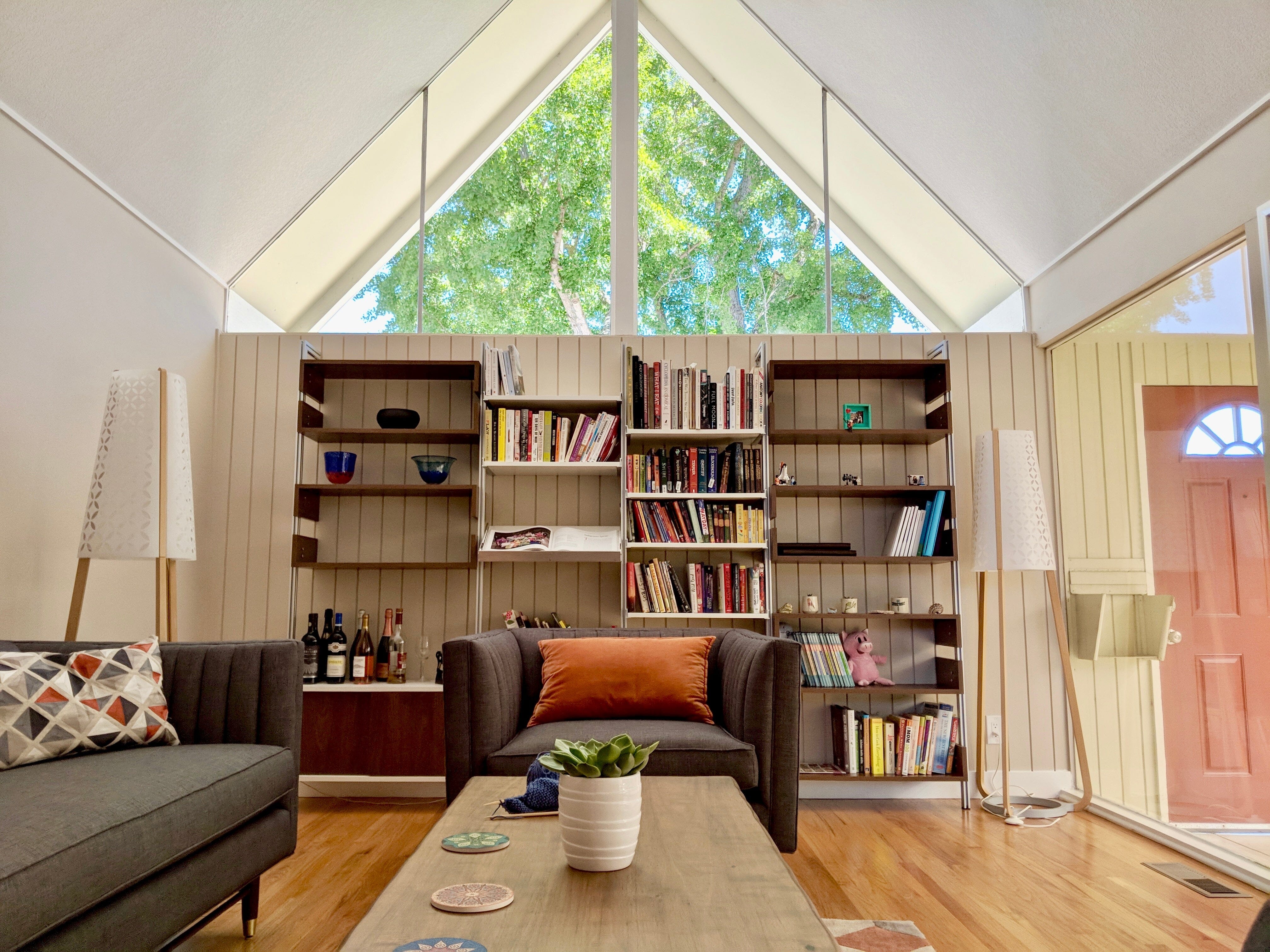 Tips to maximize space in an A-frame house with ideas including shelving and storage.