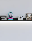 6-inch-deep Mini Mod floating aluminum shelf in black finish, shown as a compact modular display shelf.
