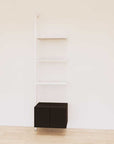 Retail display shelving extension with black shelves, white vertical post, and base cabinets in a 24-inch, one-bay configuration, shown with open display shelving.