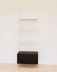 Retail display shelving unit with black shelves, white vertical posts, and base cabinets in a 31-inch configuration, shown with open display shelving.