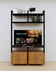 Modular media shelving unit with black shelves and black vertical posts, with Tea for Two wood cabinet storage, two bays, shown with open shelf levels.