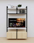 Modular media shelving unit with white shelves and black vertical posts, with Casting Light wood cabinet storage, two bays, shown with open shelf levels.
