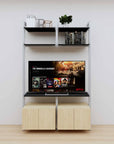 Modular media shelving unit with black shelves and satin vertical posts, with Casting Light wood cabinet storage, two bays, shown with open shelf levels.