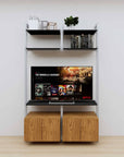 Modular media shelving unit with black shelves and satin vertical posts, with Tea for Two wood cabinet storage, two bays, shown with open shelf levels.
