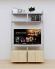 Modular media shelving unit with satin shelves and satin vertical posts, with Casting Light wood cabinet storage, two bays, shown with open shelf levels.