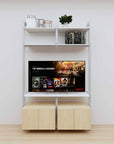 Modular media shelving unit with white shelves and satin vertical posts, with Casting Light wood cabinet storage, two bays, shown with open shelf levels.
