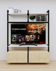 Modular media shelving unit with white shelves and black vertical posts, with Casting Light wood cabinet storage, two bays, shown with open shelf levels.