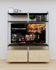 Modular media shelving unit with black shelves and satin vertical posts, with Casting Light wood cabinet storage, two bays, shown with open shelf levels.