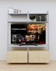 Modular media shelving unit with satin shelves and satin vertical posts, with Casting Light wood cabinet storage, two bays, shown with open shelf levels.