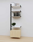 Modular media shelving extension with white shelves and black vertical post, with Casting Light wood cabinet storage, one bay, 24-inch shelf width, shown with open shelf levels.