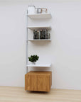 Modular media shelving extension with white shelves and satin vertical post, with Tea for Two wood cabinet storage, one bay, 24-inch shelf width, shown with open shelf levels.