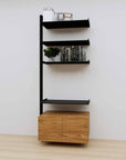 Modular media shelving extension with black shelves and black vertical post, with Tea for Two wood cabinet storage, one bay, 31-inch shelf width, shown with open shelf levels.