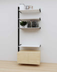 Modular media shelving extension with white shelves and black vertical post, with Casting Light wood cabinet storage, one bay, 31-inch shelf width, shown with open shelf levels.