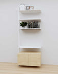 Modular media shelving extension with white shelves and white vertical post, with Casting Light wood cabinet storage, one bay, 31-inch shelf width, shown with open shelf levels.