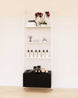 Retail display shelving unit with black shelves, white vertical posts, and base cabinets in a 31-inch, one-bay configuration, shown with open display shelving.