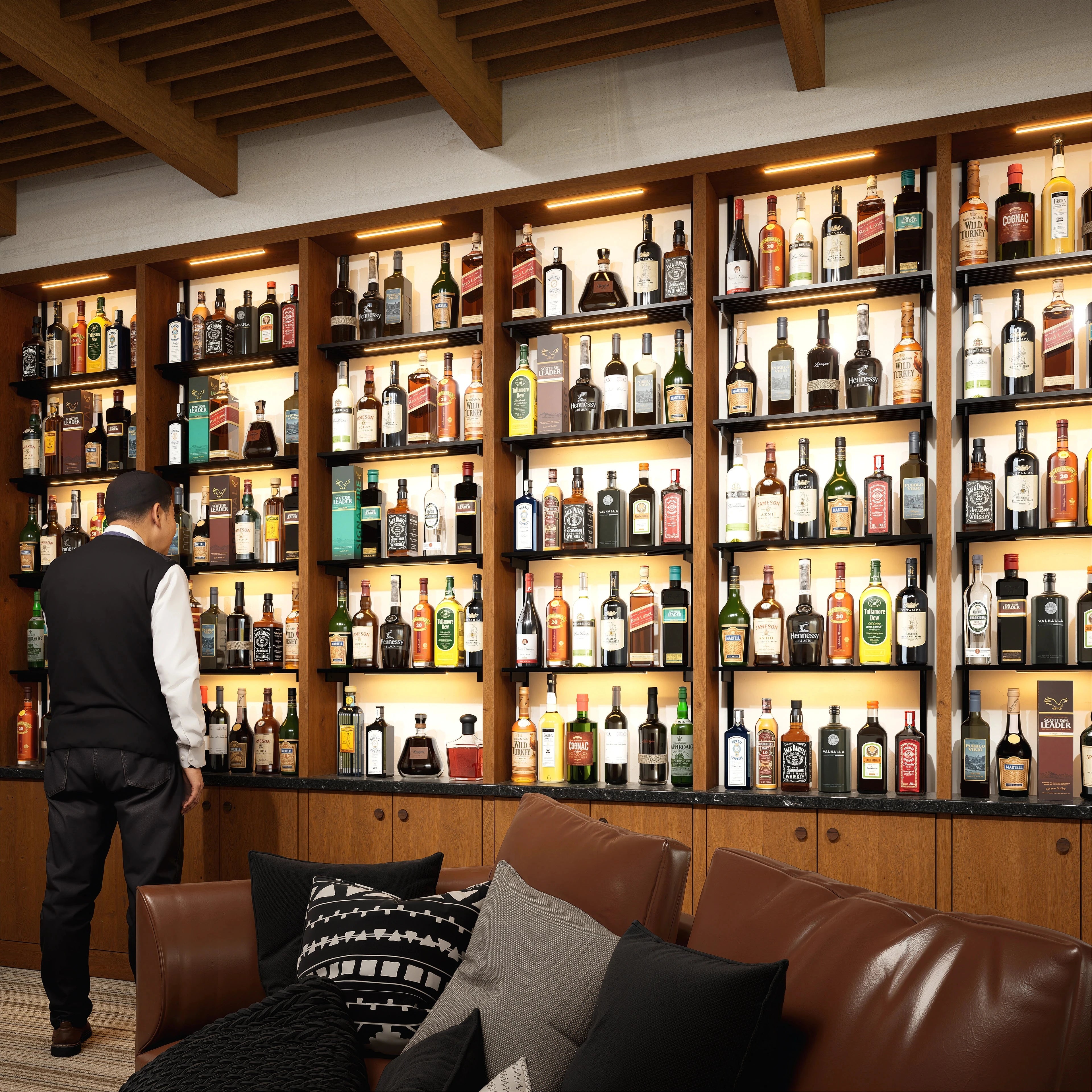 Bottle display shelving unit with black shelves, black vertical posts, and one bay.